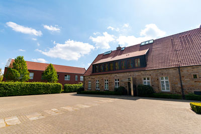 Building by street against sky