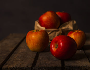 Close-up of apples on table against black background