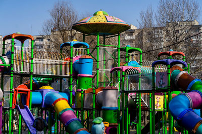 View of playground against clear blue sky