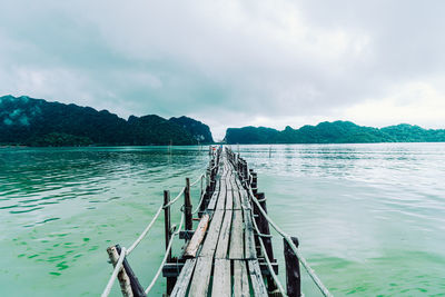 Pier over lake against sky