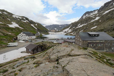 Scenic view of buildings and mountains against sky