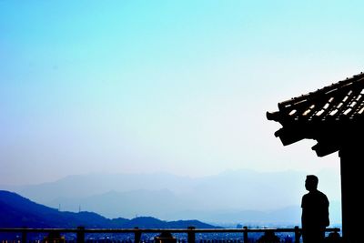 Silhouette of woman against clear sky