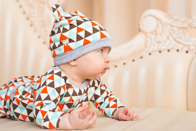 Cute baby girl sitting at home