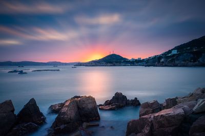 Scenic view of sea against sky at sunset