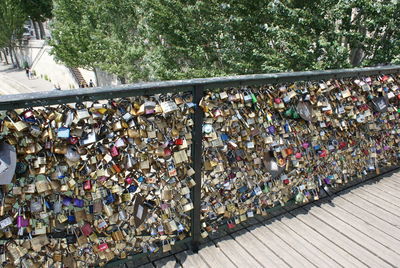 Low angle view of padlocks on tree against sky