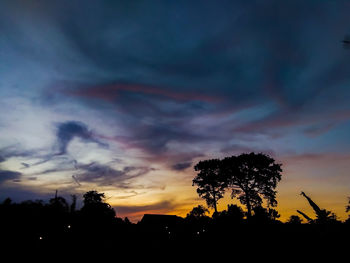 Low angle view of silhouette trees against sky during sunset