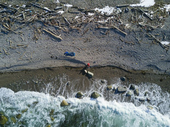 Drone shot of hiker at sea shore during winter
