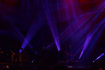 Crowd at illuminated music concert at night