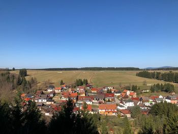 Townscape against clear blue sky
