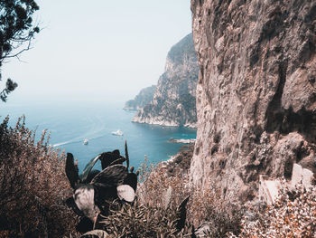 Panoramic shot of rocks on sea against sky