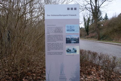 Information sign on field by road in forest