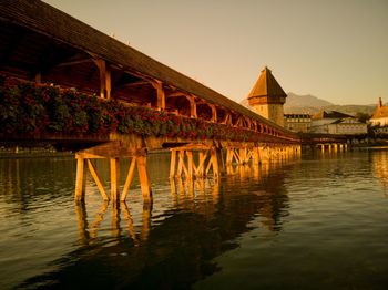 Bridge over river against buildings