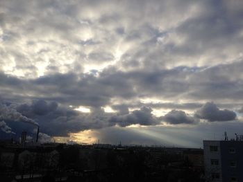 View of cityscape against cloudy sky