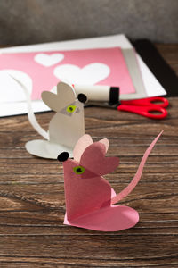 Close-up of heart shape on pink table