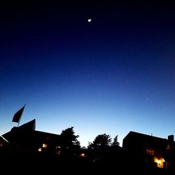 Low angle view of silhouette buildings against sky at night