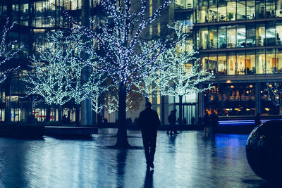 Man walking in illuminated building at night