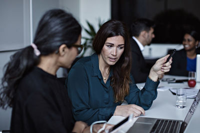 Business people discussing while working at conference table in board room