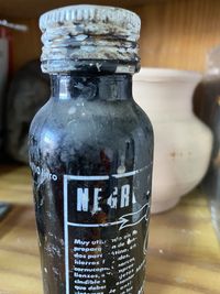 Close-up of wet glass bottle on table