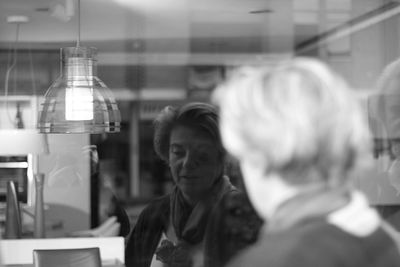 Reflection of woman on store window