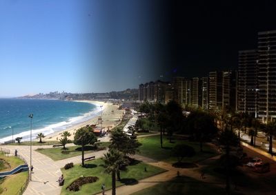 Panoramic view of city by sea against clear sky