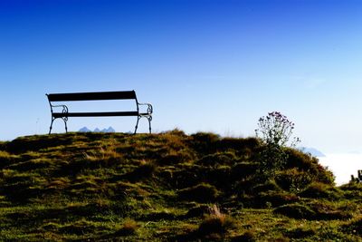 Lifeguard hut on field against clear sky