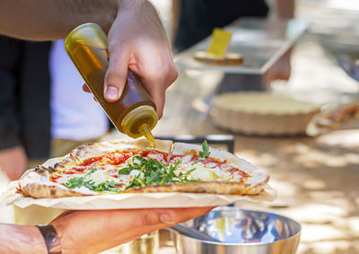 Midsection of person preparing food in restaurant