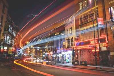 Illuminated city street and buildings at night