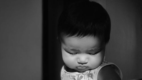 Close-up portrait of cute girl looking down