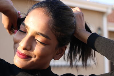 Close-up portrait of a smiling young woman