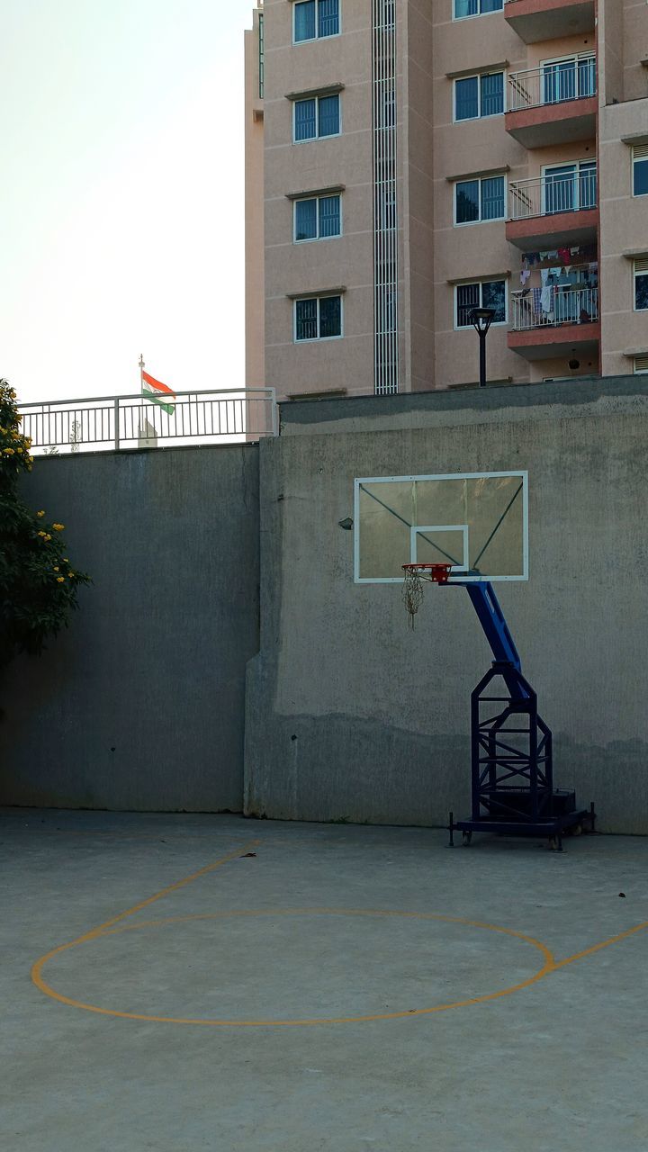 architecture, building exterior, built structure, wall, basketball, city, building, urban area, basketball hoop, facade, no people, day, street, outdoors, nature