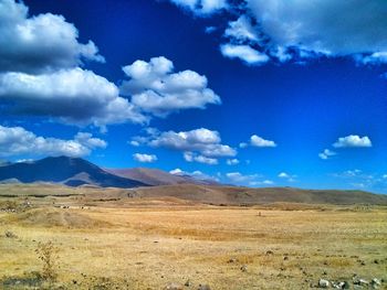 Scenic view of mountains against cloudy sky