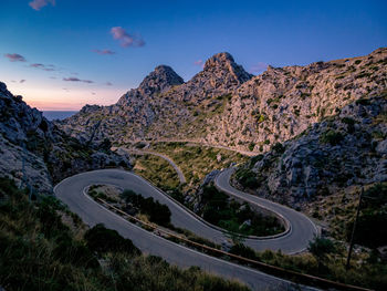 High angle view of road by mountain against sky