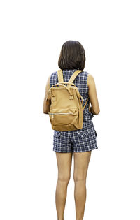 Rear view of woman standing against white background