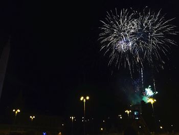 Low angle view of firework display at night