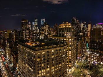 High angle view of illuminated buildings in city at night