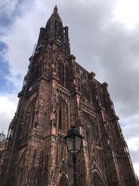 Low angle view of cathedral against cloudy sky