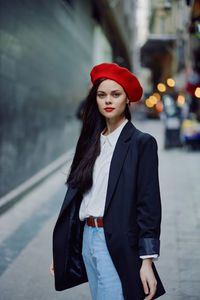 Portrait of young woman standing in city