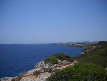 Scenic view of sea against clear blue sky