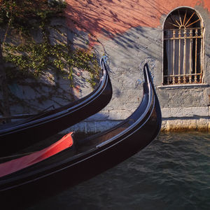 Gondolas in canal against building