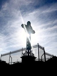 Low angle view of silhouette statue against sky