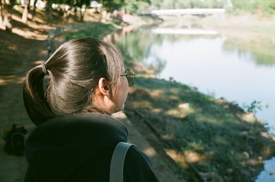 Rear view of man looking at lake