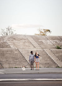 Children walking on steps against sky