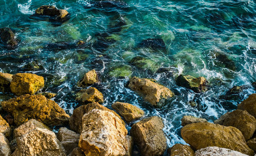 High angle view of rocks in sea