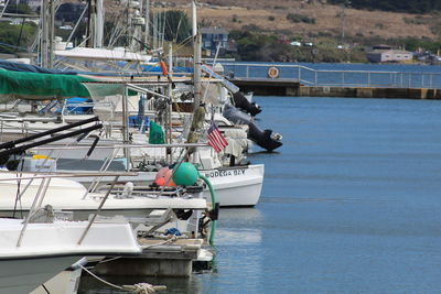 View of fishing boats moored at harbor