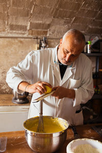 Midsection of man preparing food on table