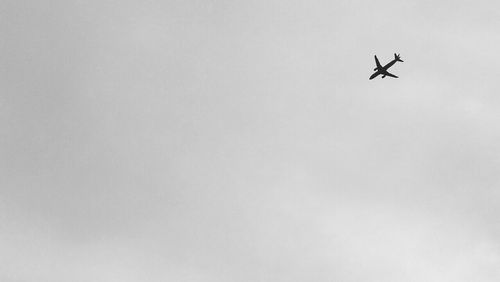 Low angle view of airplane flying in sky