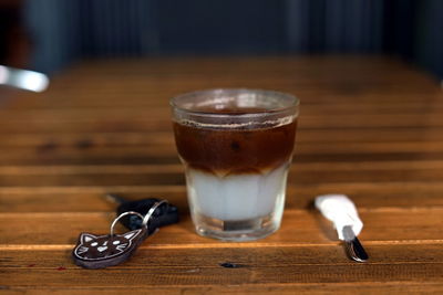 Coffee and car key on a wooden table