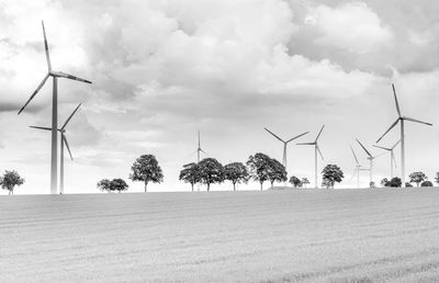 Traditional windmill on field against sky