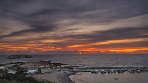 Scenic view of beach against sky during sunset