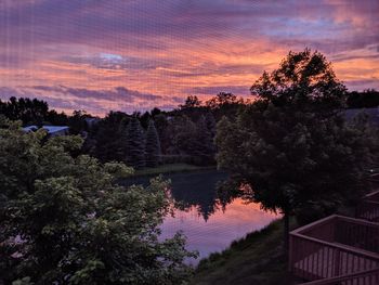 Scenic view of lake against sky at sunset